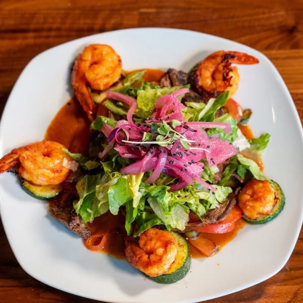 Mi Sabor Mexican Kitchen's grilled shrimp and steak salad with pickled onions and zucchini.
